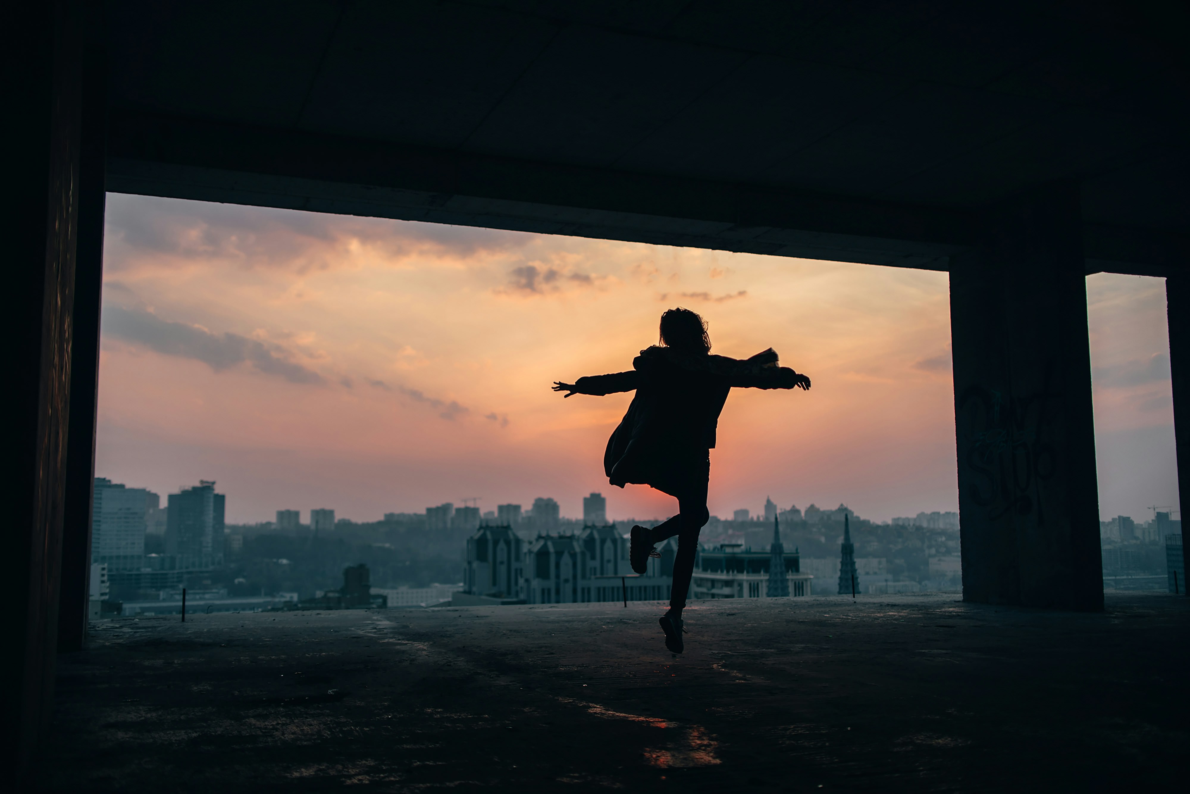 Person silhouette against city sunset